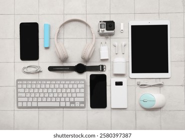 Composition with different modern gadgets on light tile background
