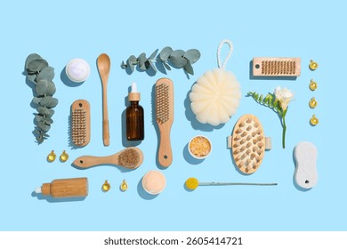 Composition with different spa accessories and eucalyptus branches on color background