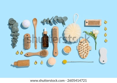 Composition with different spa accessories and eucalyptus branches on color background