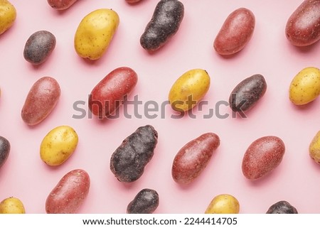 Composition with different types of raw potatoes on pink background