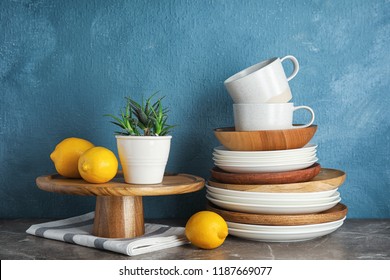 Composition and dinnerware table against color background  Interior element
