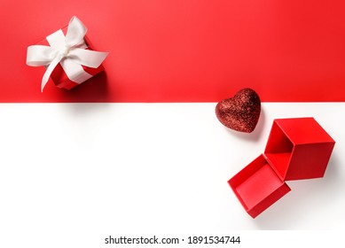 Composition To Dnb Saint Valentine. Gift Boxes And A Heart On A Red And White Background With Copy Space.