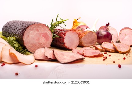 Composition With Dried, Smoked Sausages, Fresh Herbs, Spices And Onions On A Food Paper, On White Background. Polish, Traditional Cold Cuts Made Of Meat And Spices, Horizontal View.