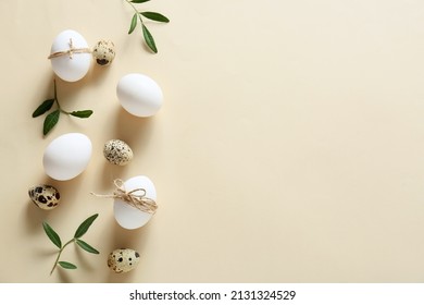 Composition and Easter eggs   green branches beige background