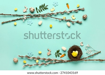 Composition with Easter eggs and pussy willow branches on turquoise background