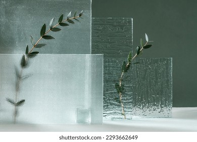 Composition empty podium material glass geometric shape. Pastel green background. Beautiful background made of natural materials for product presentation