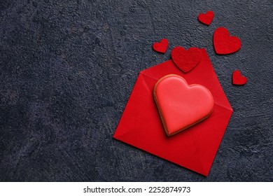 Composition with envelope, sweet cookie and decor on dark background. Valentines Day celebration