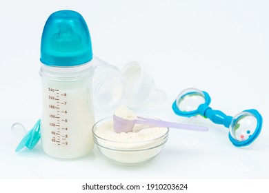 Composition With Feeding Bottle Of Baby Milk Formula On White Table. Baby Food Concept