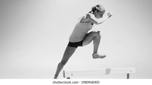 Composition Of Female Hurdle Jumper With Copy Space In Black And White. Sport And Competition Concept Digitally Generated Image.