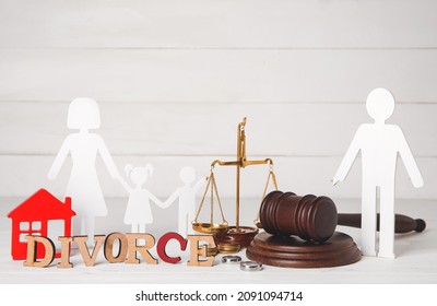 Composition with figures of family and word DIVORCE on light wooden background