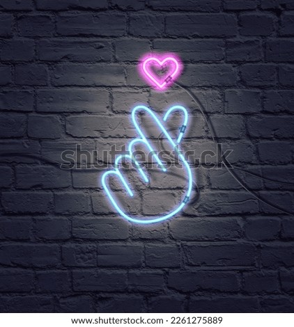Composition of Flat lay ultraviolet neon colors.Retro Neon K-POP sign.Sign of Finger Heart with colorful neon lights isolated on brick wall.Minimal concept of love.Creative art,minimal aesthetics