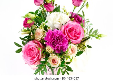 Composition of flowers in a pink hatbox. Tied with wide white ribbon and bow. - Shutterstock ID 1044834037