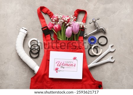 Composition with flowers, plumber's items, uniform and greeting card with text HAPPY WOMEN'S DAY on grey grunge background