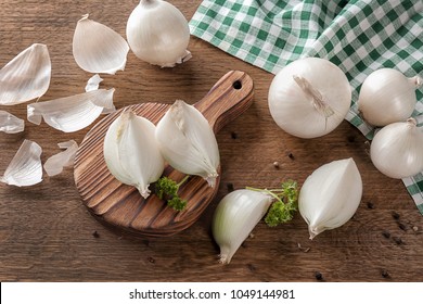 Composition with fresh cut onion and spices on wooden table