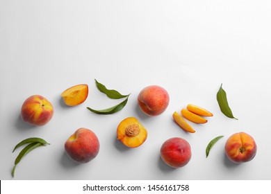 Composition with fresh peaches on white background, top view