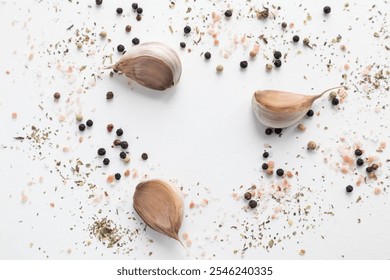 A composition of garlic, pepper and pink Himalayan salt on a white background. Background with food. - Powered by Shutterstock