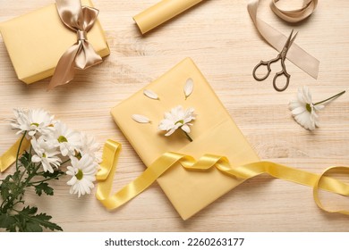 Composition with gift boxes, ribbon, scissors and flowers on wooden background. Women's Day celebration - Powered by Shutterstock