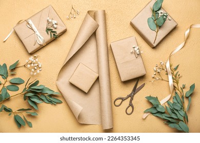 Composition with gift boxes, wrapping paper, gypsophila flowers and eucalyptus branches on color background. Women's Day celebration