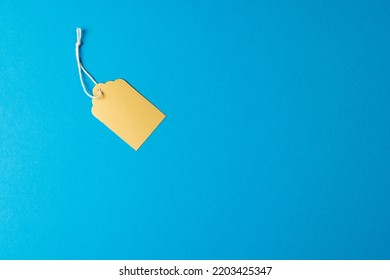 Composition Of Gift Tag With Copy Space On Blue Background. Retail, Shopping And Black Friday Concept.