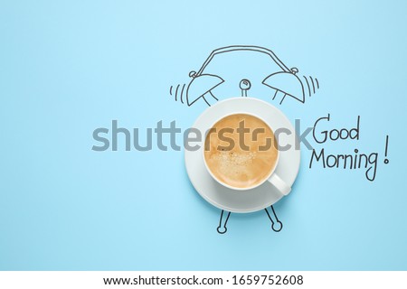Composition with Good Morning wish and aromatic coffee on light blue background, top view. Space for text