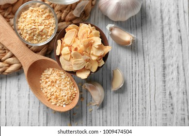 Composition with granulated dried garlic and flakes on wooden background - Powered by Shutterstock