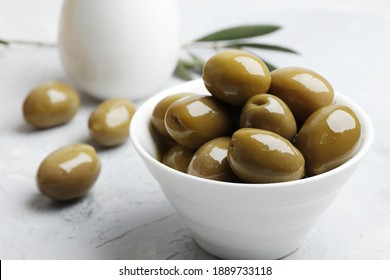 Composition of green olives, oil, spices, gravy boats, on a white background. - Powered by Shutterstock