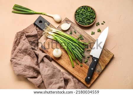 Composition with green onion on color background