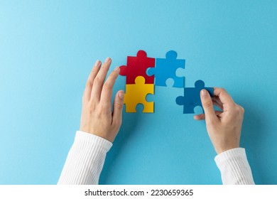 Composition of hands putting jigsaw puzzle pieces together on blue background with copy space. Medical services, healthcare and mental health awareness concept. - Shutterstock ID 2230659365