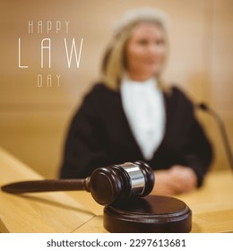 Composition of happy law day text with caucasian female judge and gavel on beige background. Law day and celebration concept digitally generated image. - Powered by Shutterstock