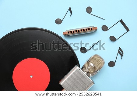 Composition with harmonica, microphone, vinyl disk and music notes on color background