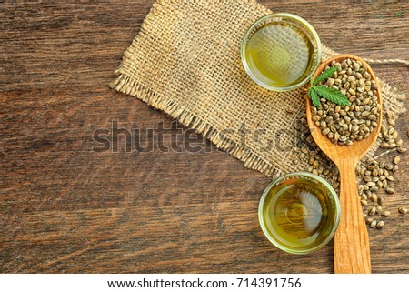 Composition with hemp oil and seeds on wooden background
