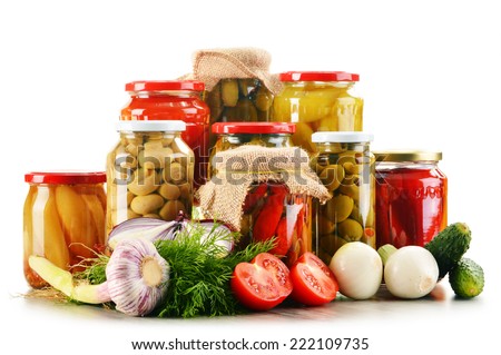 Composition with jars of pickled vegetables. Marinated food.