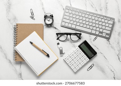 Composition with keyboard, notebooks and modern flash drive on white marble background