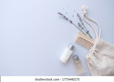 Composition With Lavender And Organic Cosmetics In Eco Bag On Blue Background. Organic SPA Beauty Products For Hair And Body Care. Flat Lay, Top View. Zero Waste Beauty Products Set.