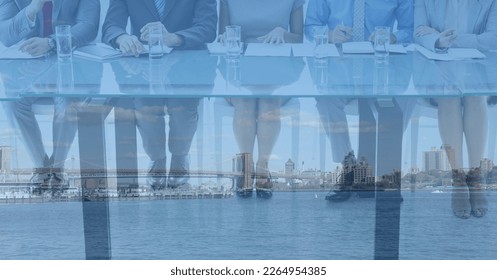 Composition of low section of business people in meeting in office over cityscape. business, finances, success and communication concept digitally generated image. - Powered by Shutterstock