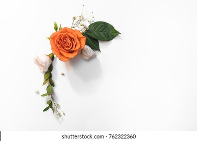 Composition made from roses and decorative addons, shaped in frame, flat lay, top view.