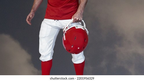 Composition of male american football player holding helmet over blue sky with clouds. sport and competition concept digitally generated image. - Powered by Shutterstock