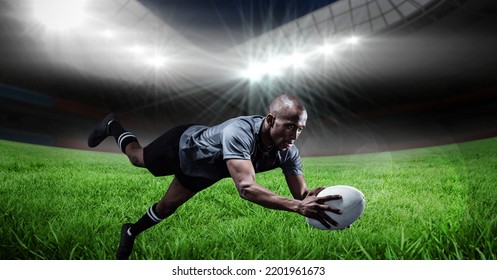 Composition of male rugby player diving holding ball on rugby pitch. sport and competition concept digitally generated image. - Powered by Shutterstock