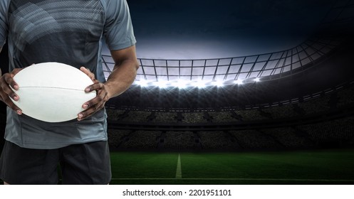 Composition of male rugby player holding rugby ball over sports stadium. sport and competition concept digitally generated image. - Powered by Shutterstock