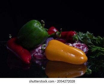 Composition Of Meat, Papper, Onion And Parsley On Glassy Surface