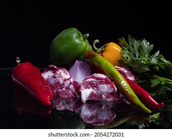 Composition Of Meat, Papper, Onion And Parsley On Glassy Surface