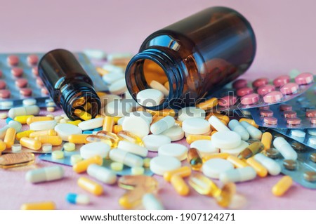 Composition of medicine bottle and pills, selective focus.