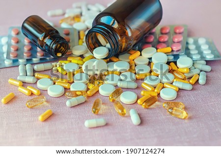 Composition of medicine bottle and pills, selective focus.