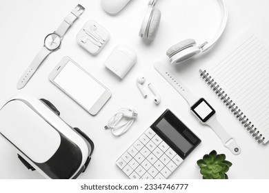 Composition with modern gadgets and notebook on white background