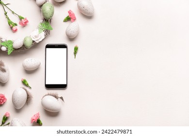 Composition with modern mobile phone, Easter eggs and flowers on light background - Powered by Shutterstock