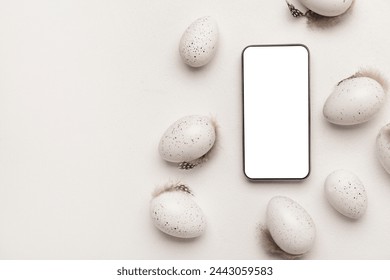 Composition with modern mobile phone and Easter eggs on light background