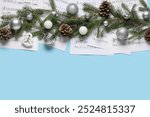 Composition with music sheets, fir branches and Christmas decorations on color background