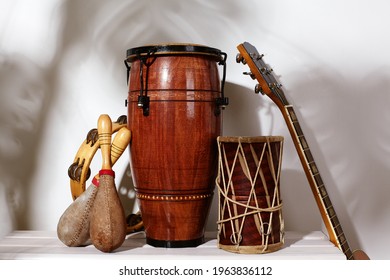 Composition Of Musical Ethnic Instrument. Maracas, Tambourine, Conga, Guitar And Ethnic Drum. Percussion Rhytm Instruments Under Palm Shade. Cuban Sound, Latin Culture, Samba And Rumba