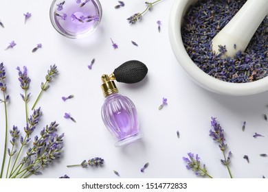 Composition With Natural Perfume And Lavender Flowers On White Background, Top View. Cosmetic Product