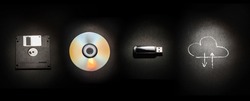 Composition On A Black Background From A Floppy Disk, A Laser Disk, A USB Flash Drive And A Cloud Storage Symbol. The Evolution Of Storage Media.